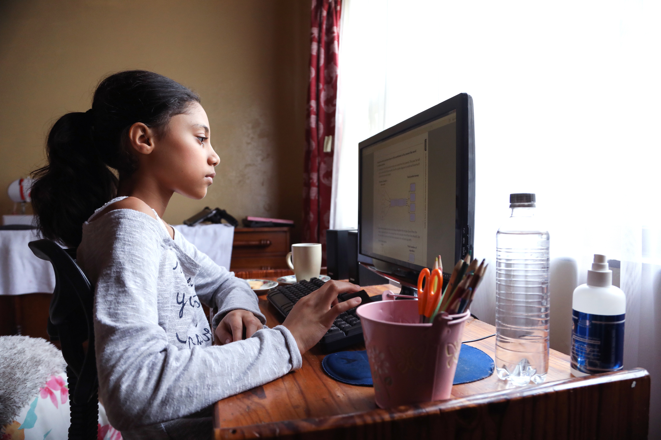 young girl using a desktop computer