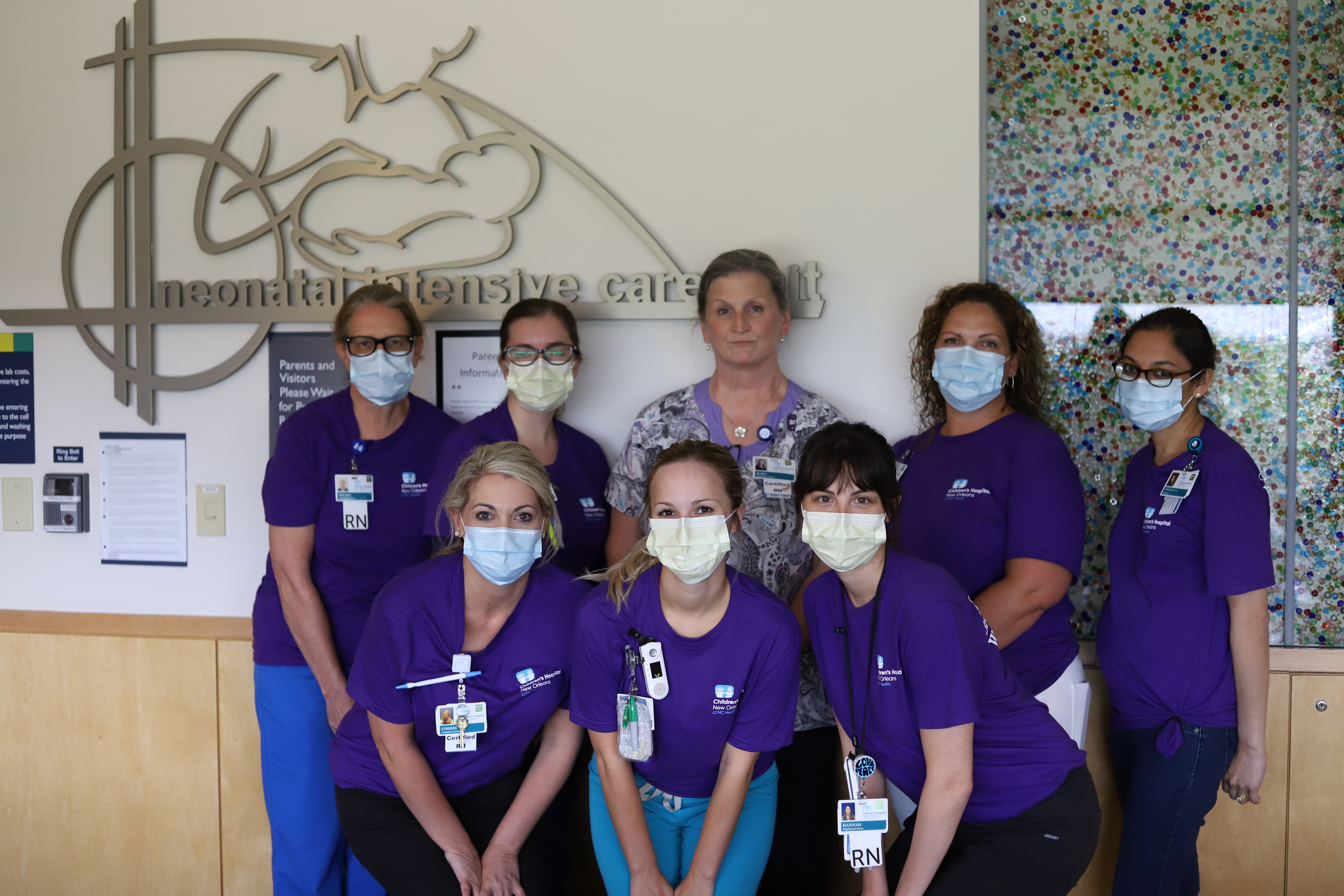 a group of nurses in purple uniform