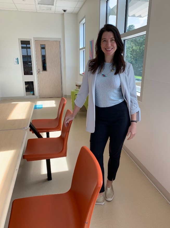 doctor standing next to orange chairs
