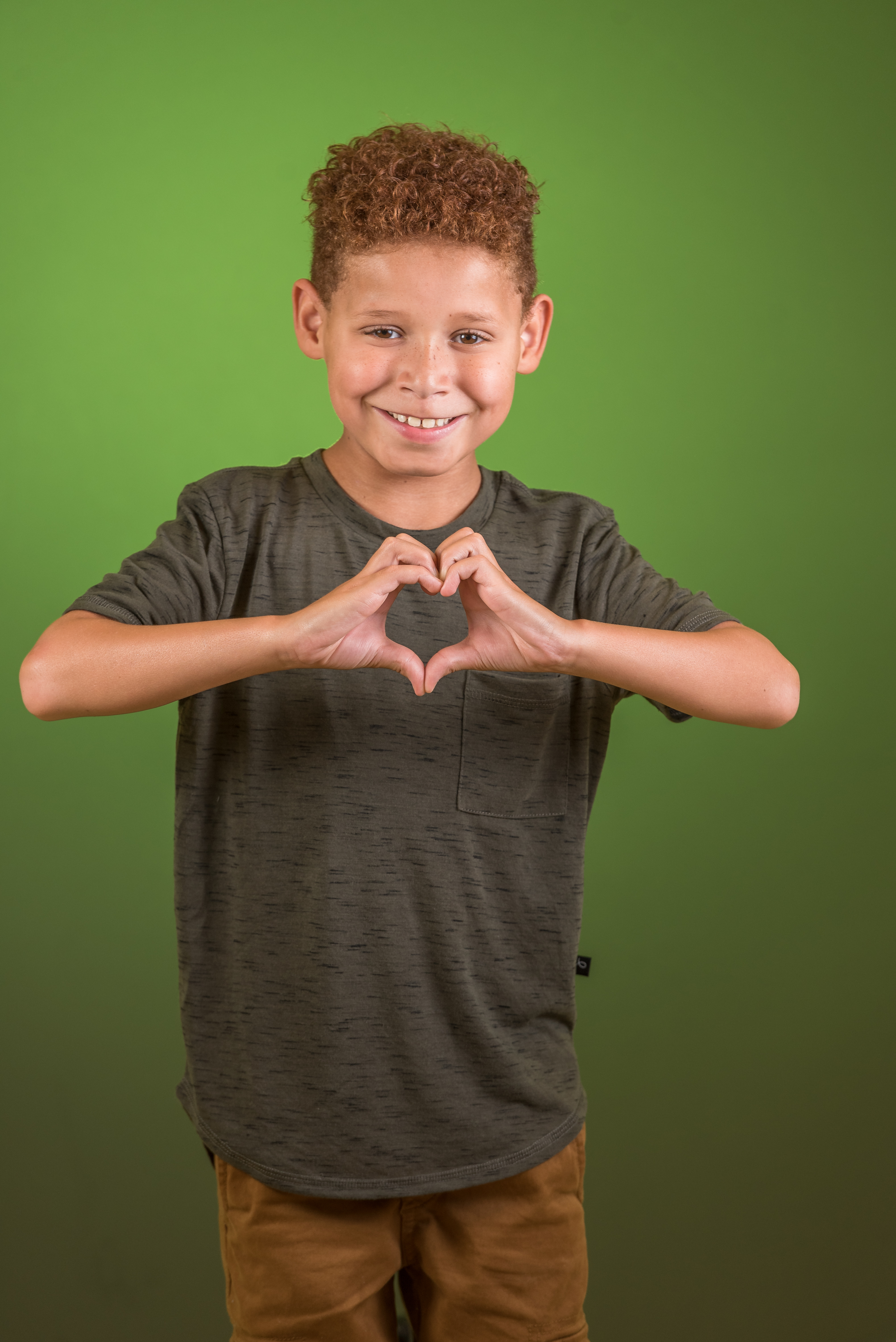 kid making heart with hands