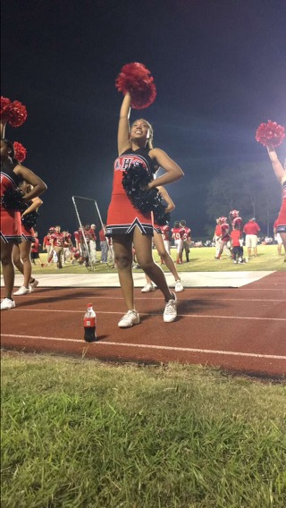 cheerleader with red pom pom