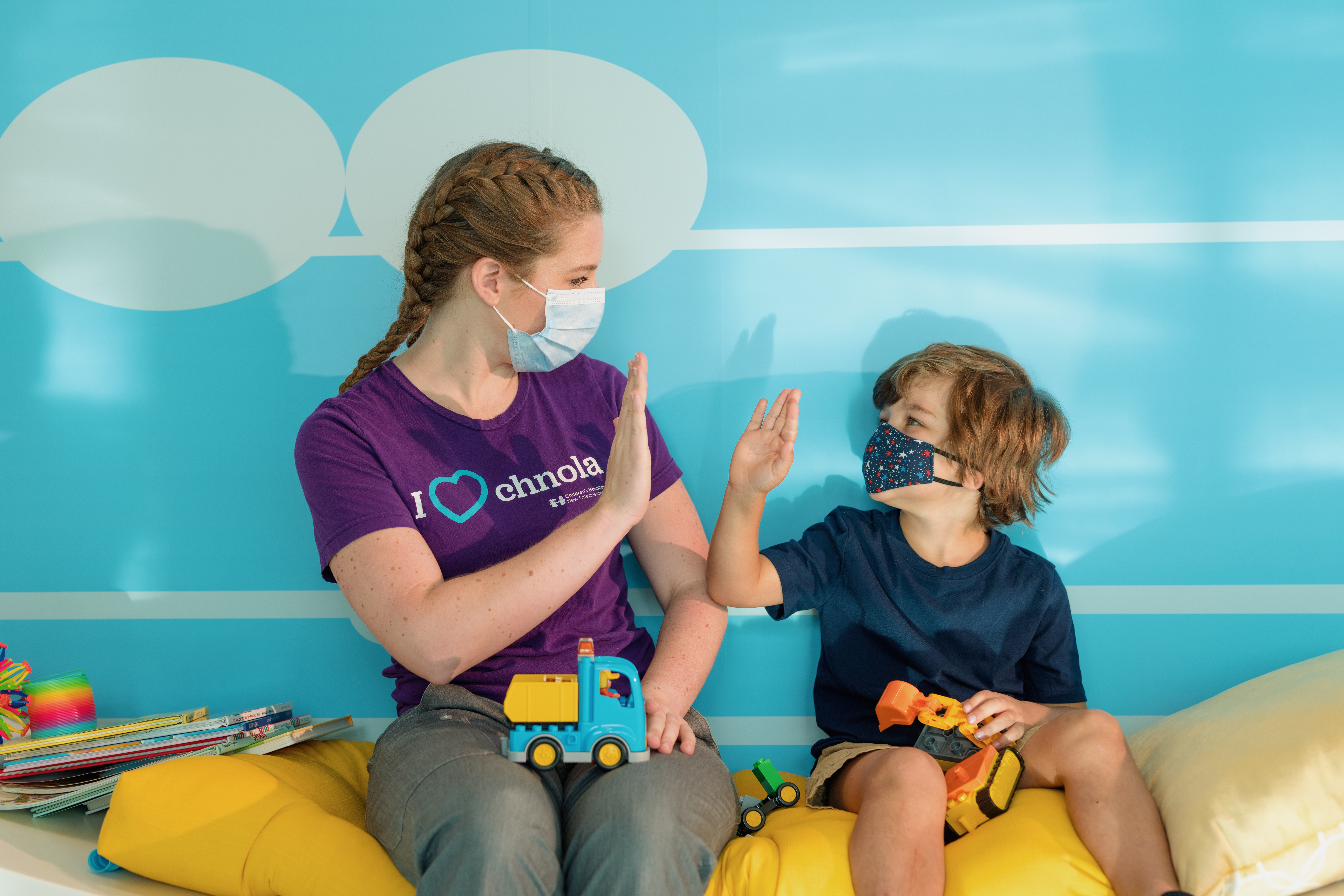 Provider and child high five during therapy