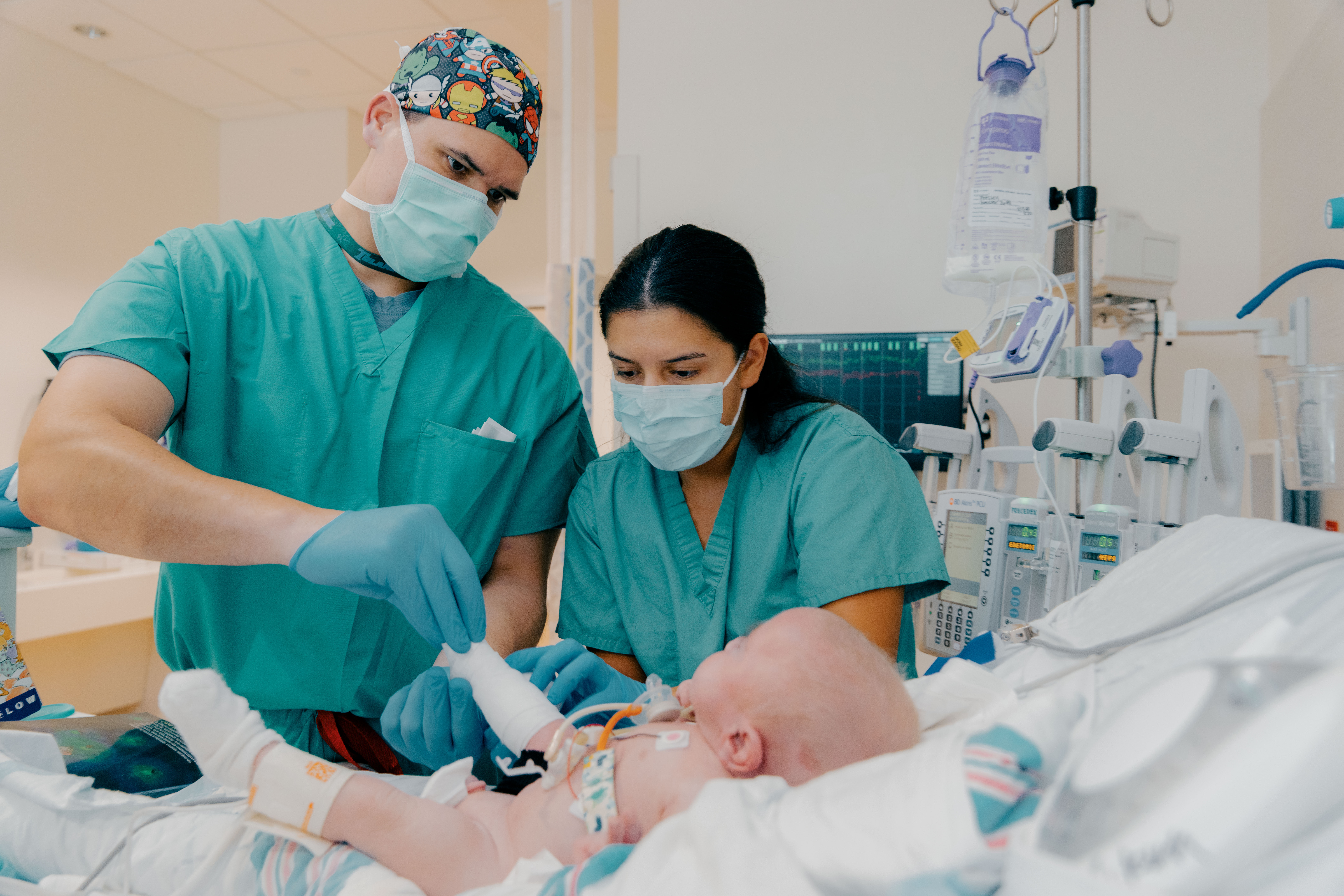 infant being monitored by doctors