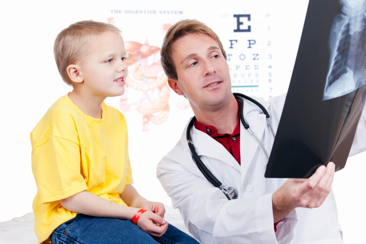 Doctor explaining X-ray to a child patient