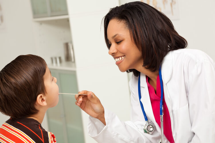 African American physician doing a checkup on a small patient 