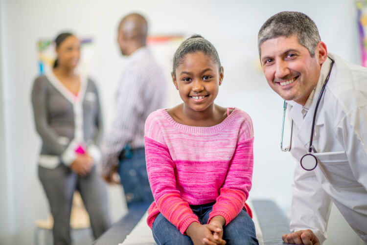 young african american girl with physician 