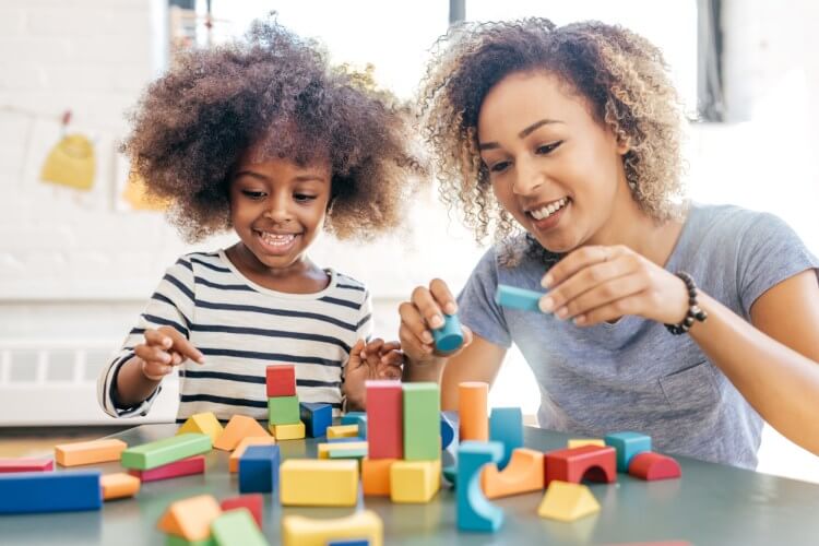 Mother and daughter playing with blocks