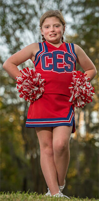 Little girl in a red CES cheerleader uniform